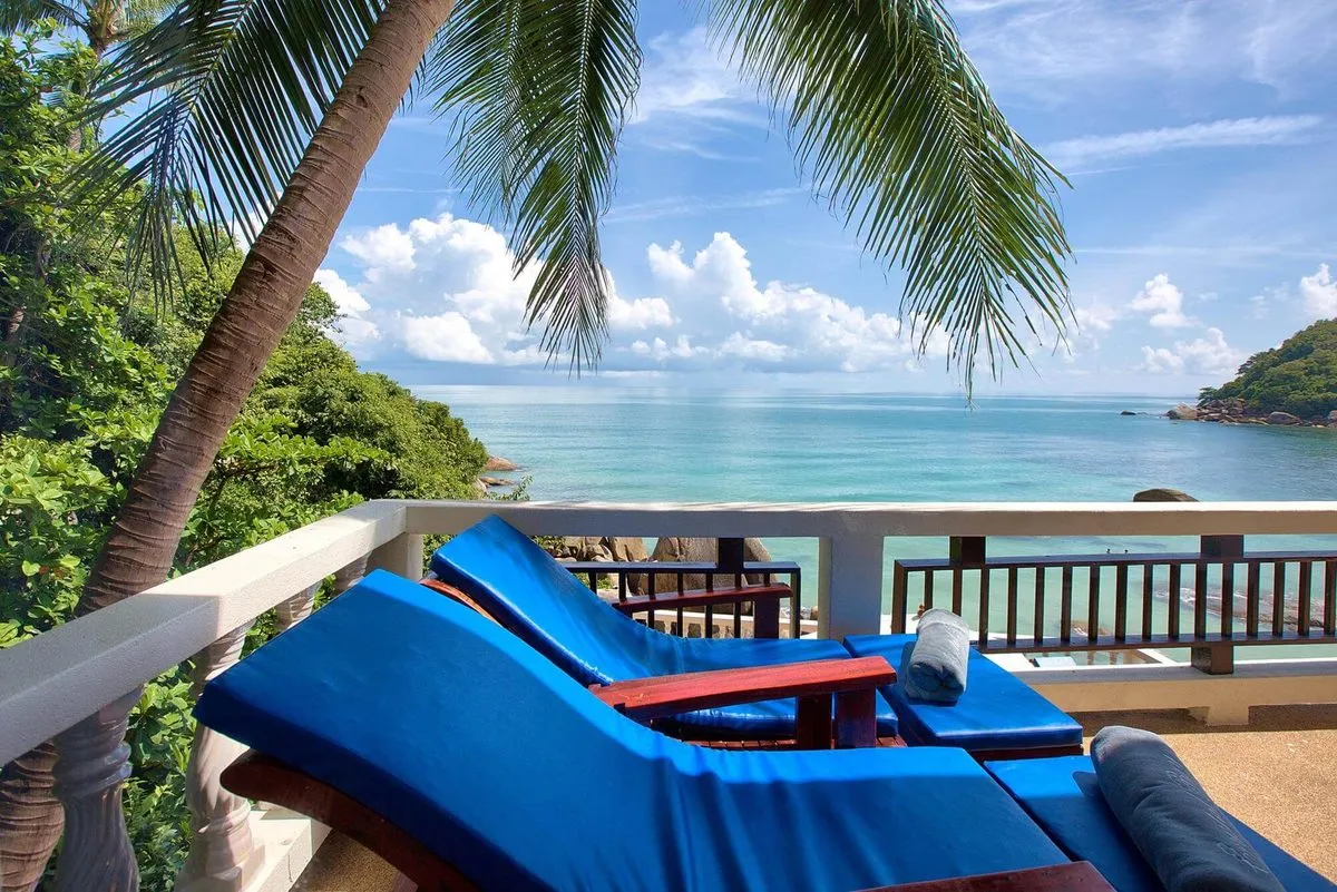 Sun loungers on a private balcony looking over the bay