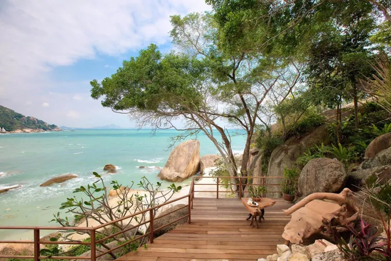 Timber deck set among the boulders, looking out over the water